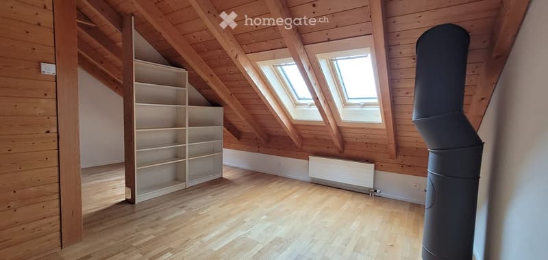 wooden ceiling, wooden floor, white shelves, two windows, white wall, white radiator