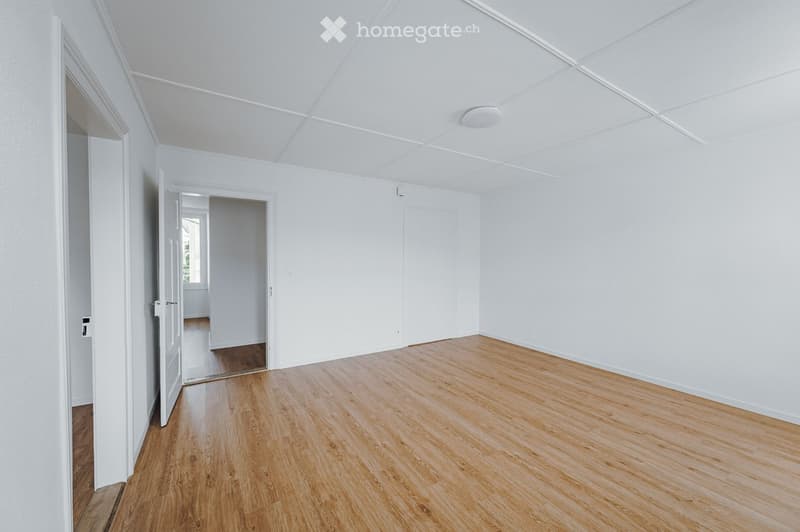Unfurnished Room. Completely empty room with white walls, wooden floor, and ceiling. No furniture or equipment.
