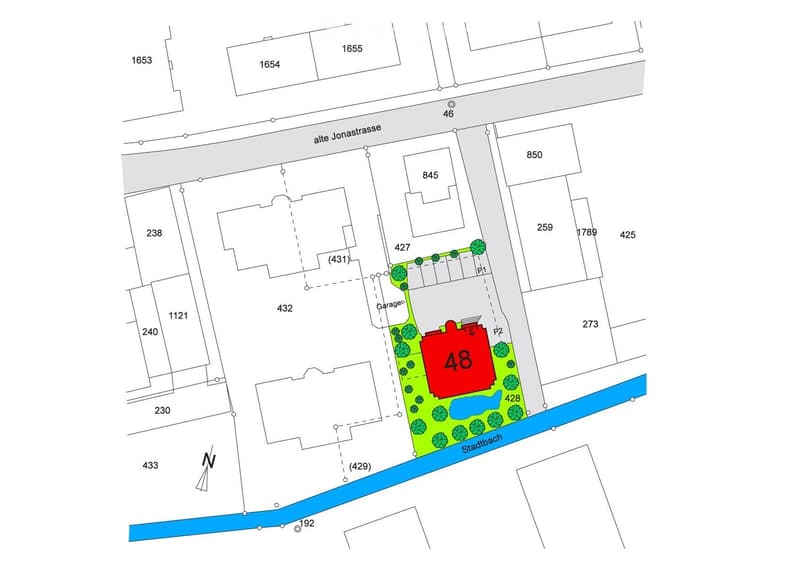 a house, red marked with number 48, garage, and parking area is on the plot
