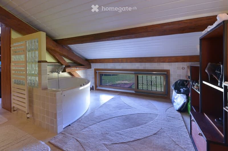 Bathroom. Bathroom with a large bathtub, wooden beams, tiled walls, and a window with a view.