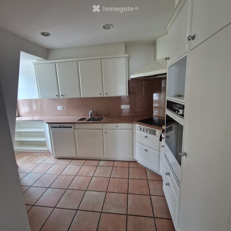White cabinets, stainless steel sink, integrated dishwasher, built-in oven, tiled floor
