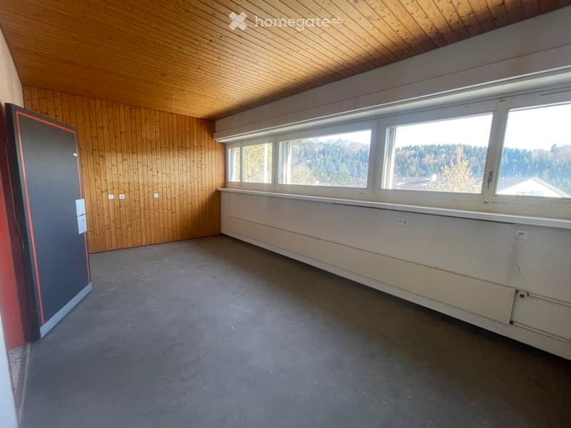 Empty room with wooden wall, large windows, gray floor