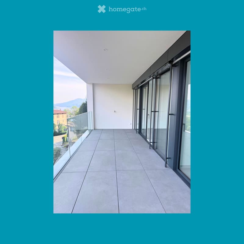 Balcony / Terrace. Empty balcony with glass railings, tiled floor, and sliding glass doors.