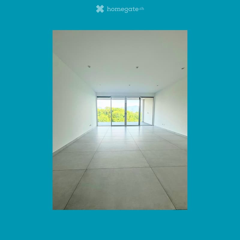 Unfurnished Room. An empty room with white walls, tiled floor, and sliding glass doors leading to a balcony with a view of trees.