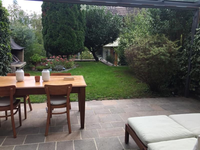 {"visible_features": ["Garden / Outdoor Area"], "type": "Garden / Outdoor Area", "objects": ["dining table", "chairs", "vases", "candles", "outdoor sofa", "grill"], "description": "Outdoor dining area with a wooden table and chairs, surrounded by a garden