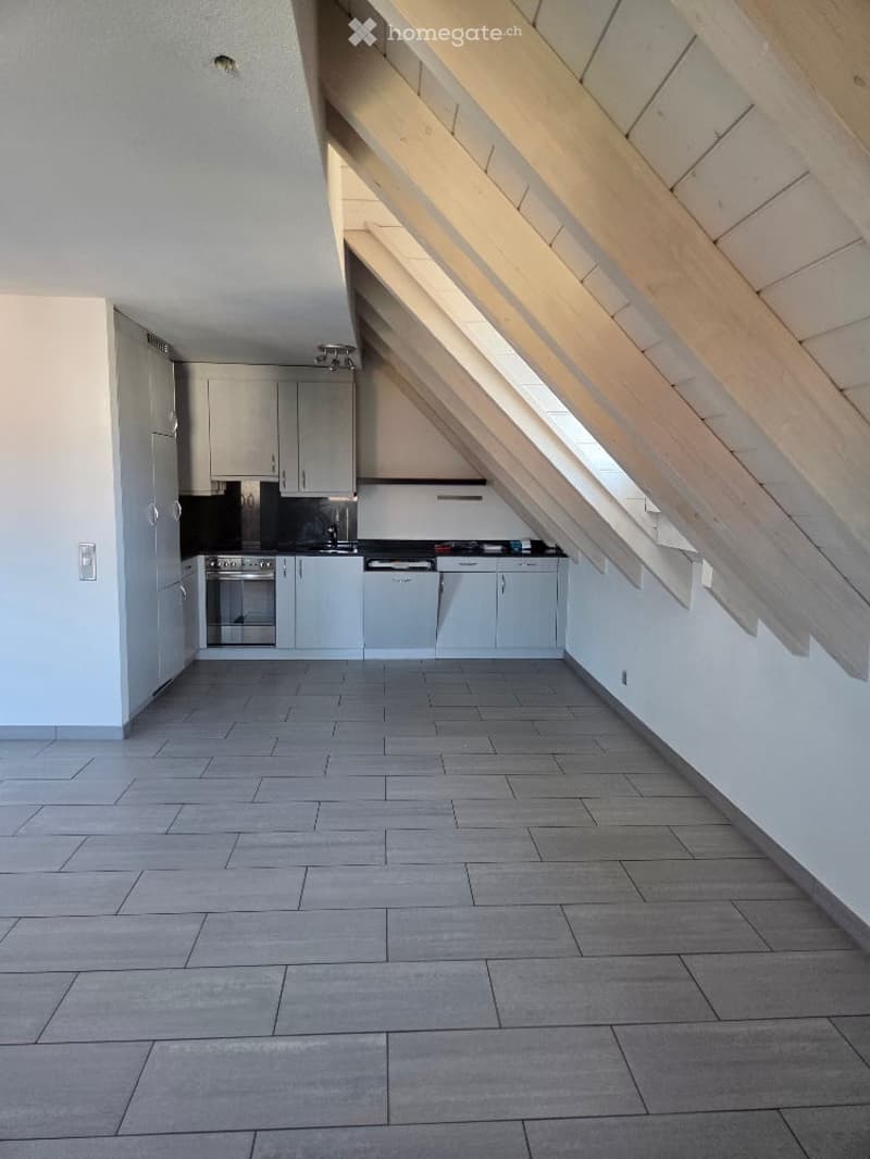 kitchen with oven, sink, and cabinets, large open living space, slanted ceiling