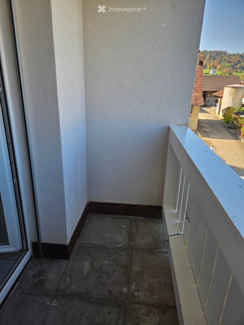 white wall, tile floor, white railing, glass door, outside view, mountains