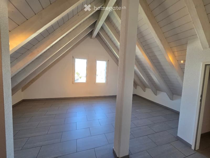 empty attic with white wooden beams, gray tiled floor, two windows