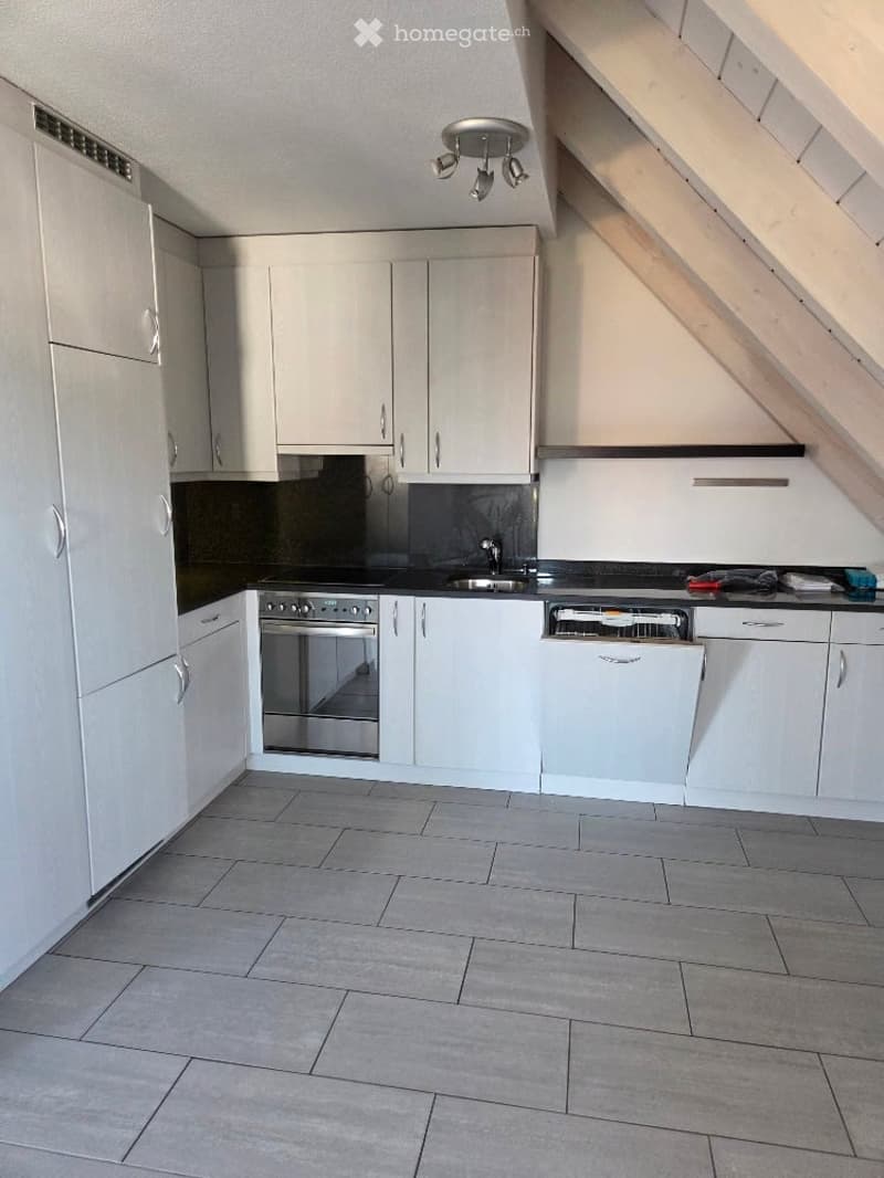 white cabinets, grey tiled floor, built-in dishwasher, stainless steel appliances