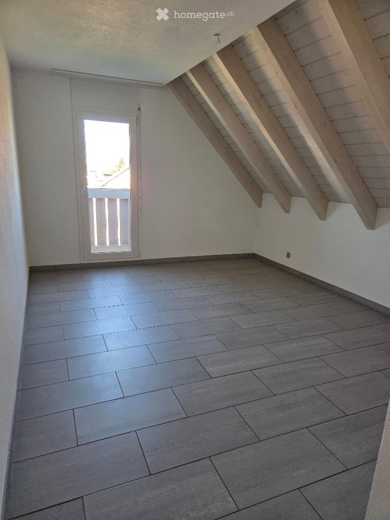 empty attic room, wooden beams, grey tiles, window, door