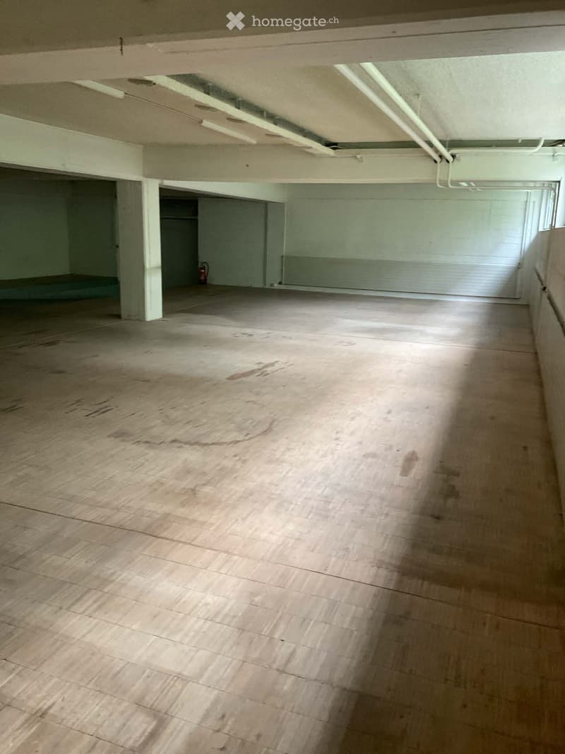 Unfurnished Room. Empty room with wooden flooring, white walls, and visible structural beams. No furniture or equipment present.