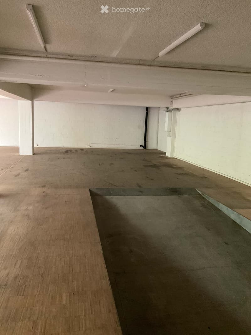 Unfurnished Room. Empty room with wooden flooring and white walls, featuring a raised ground floor area with a concrete step leading up to the main level.