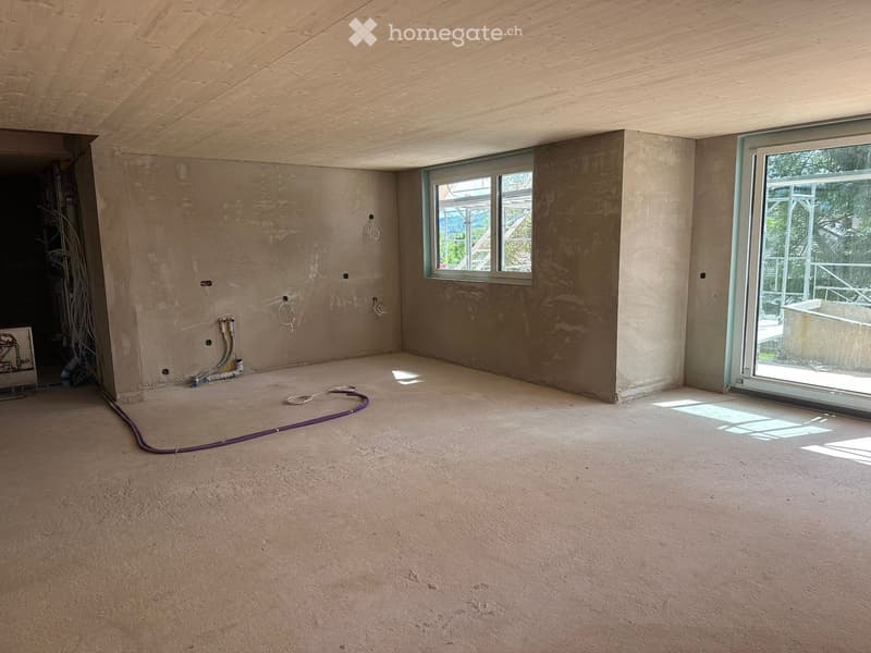 Unfurnished Room. Empty room with unfinished walls, concrete floor, and large windows, including a sliding glass door leading outside.