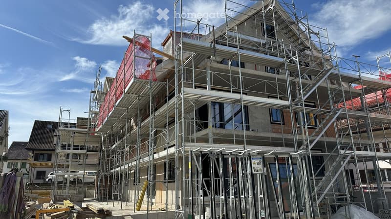 House under construction, scaffolding, red roof, windows, white car parked