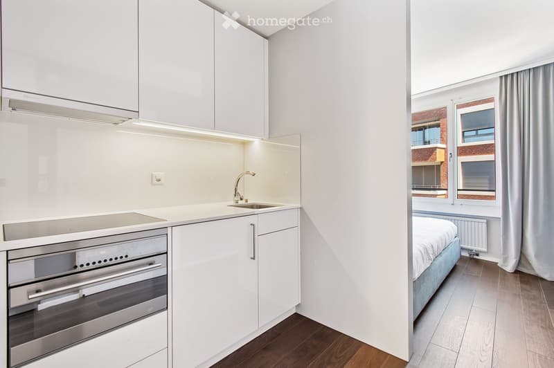 modern kitchen with white cabinets, stainless steel appliances, induction cooktop, sink, faucet, built-in dishwasher, built-in washing machine
