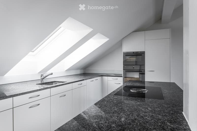 white cabinets, granite countertop, stainless steel faucet, double oven, skylight
