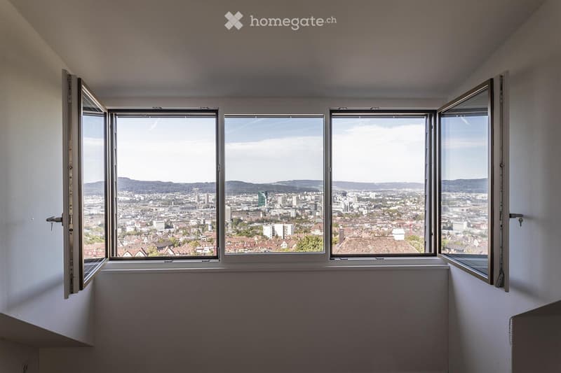 Corner room with large window opening to cityscape view, white walls, simple and clean design