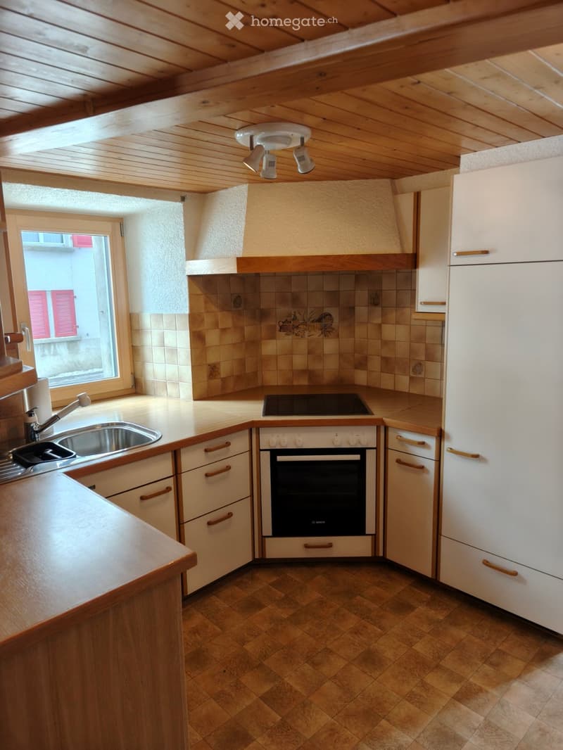 kitchen includes white cabinetry, a stainless steel sink, tile backsplash, an oven, and a stove.