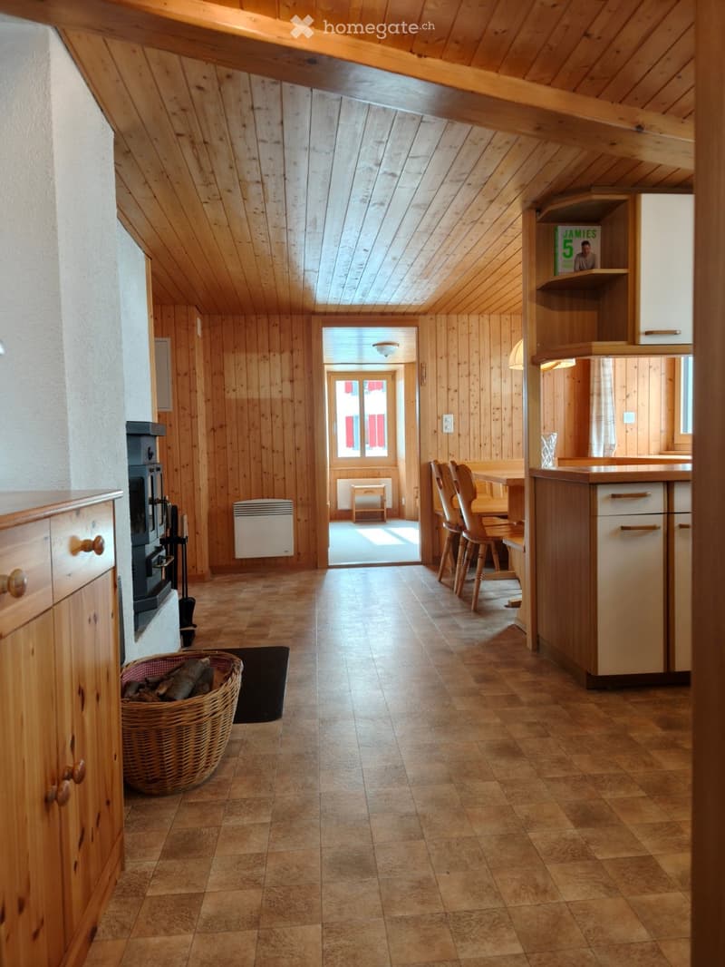 Wooden wall, fireplace, kitchen, dining table, wooden cabinets, floor