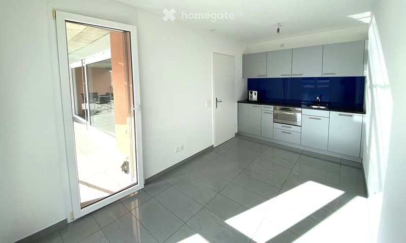 modern kitchen, sliding glass door to terrace, white cabinets, blue backsplash, under cabinet lighting, white tile flooring