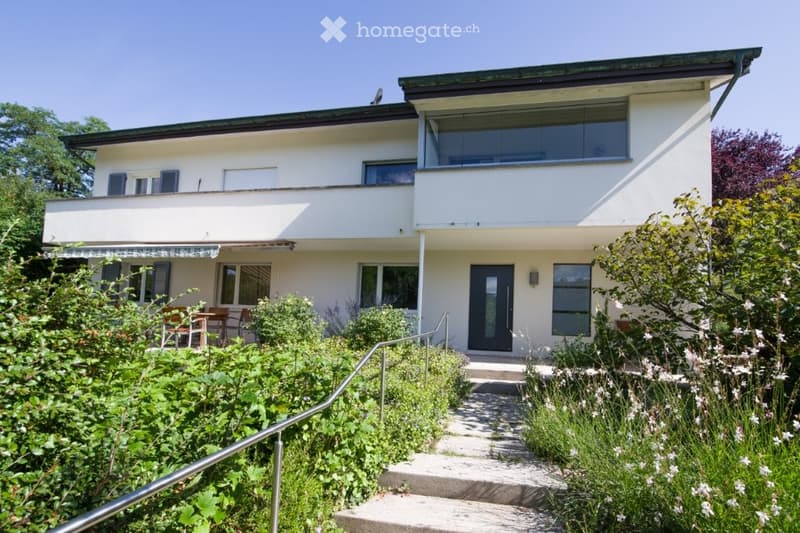 white two-story house, balcony, staircase to the entrance, garden