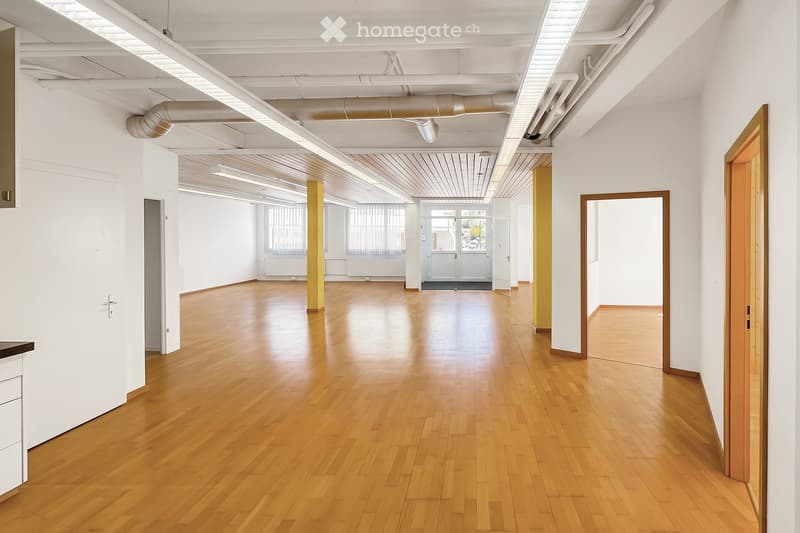 Unfurnished Room. Empty room with wooden flooring, white walls, and exposed ceiling beams. No furniture or equipment present.
