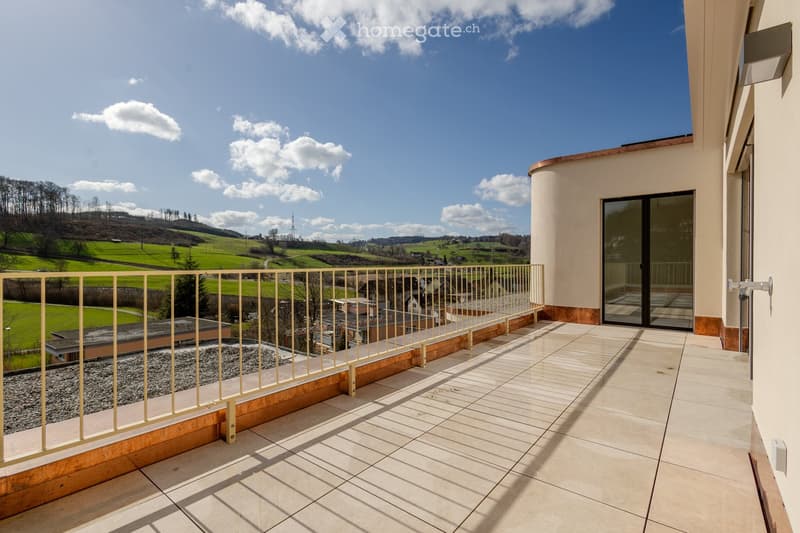 Balcony with railings, sliding doors, tiled floor, green field and mountain view