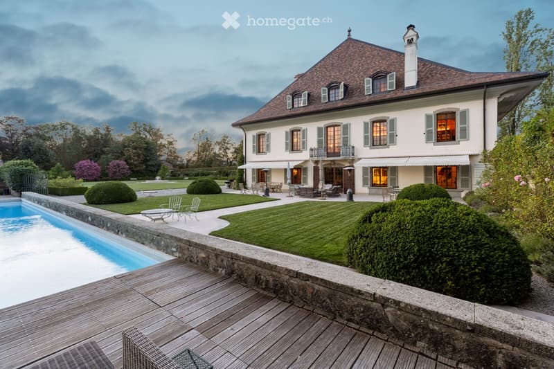 House. Large villa, red roof, white exterior walls, swimming pool, outdoor seating, lawn, trees