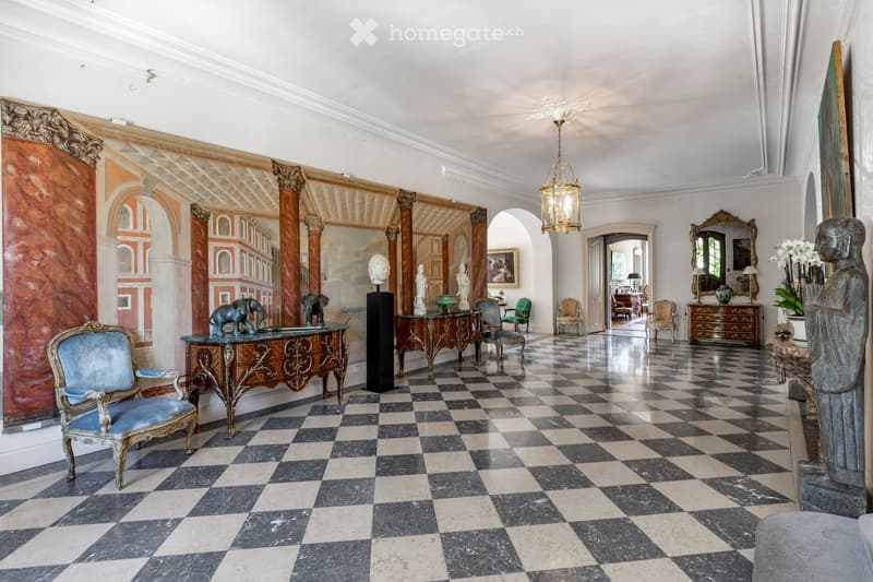 Other. {"visible_features": [],    "type": "Room",    "description": "checkered floor, large mural, chandelier, furniture, sculptures, marble top tables, paintings on wall",    "localized_descriptions":        {        "EN": "Room: checkered floor, l