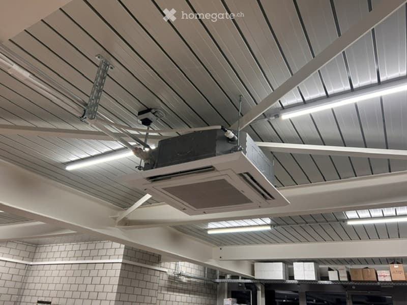 Other. Ceiling with modern linear lighting and an air conditioning unit installed, white tiled walls visible below.