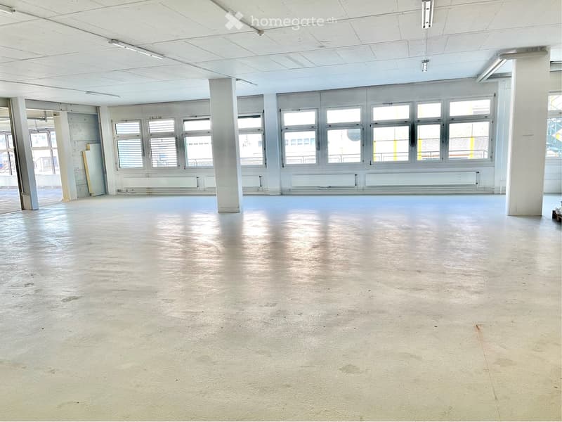 Unfurnished Room. Empty room with bare walls, concrete floor, large windows, and structural columns.