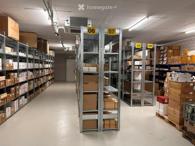 Other. Warehouse with metal shelving units filled with cardboard boxes and storage items, organized in rows.