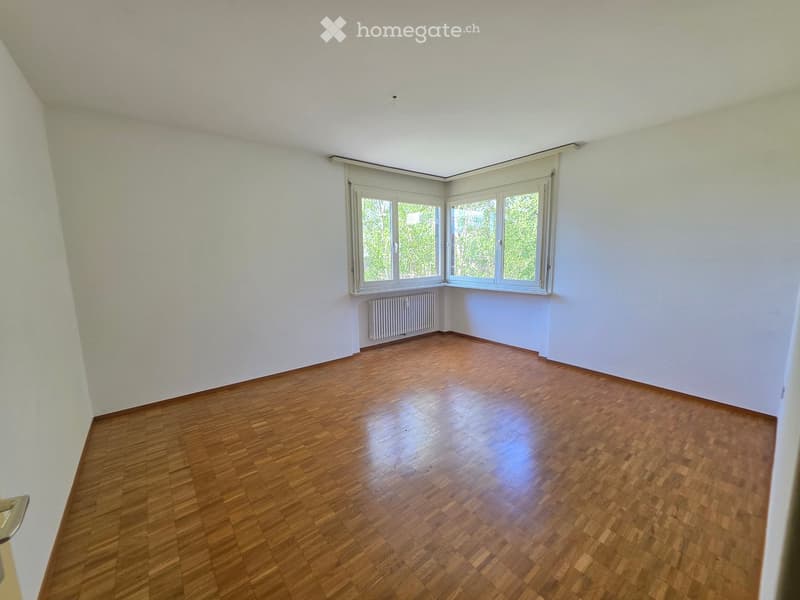 empty room, white walls, wooden floor, large windows, white radiator