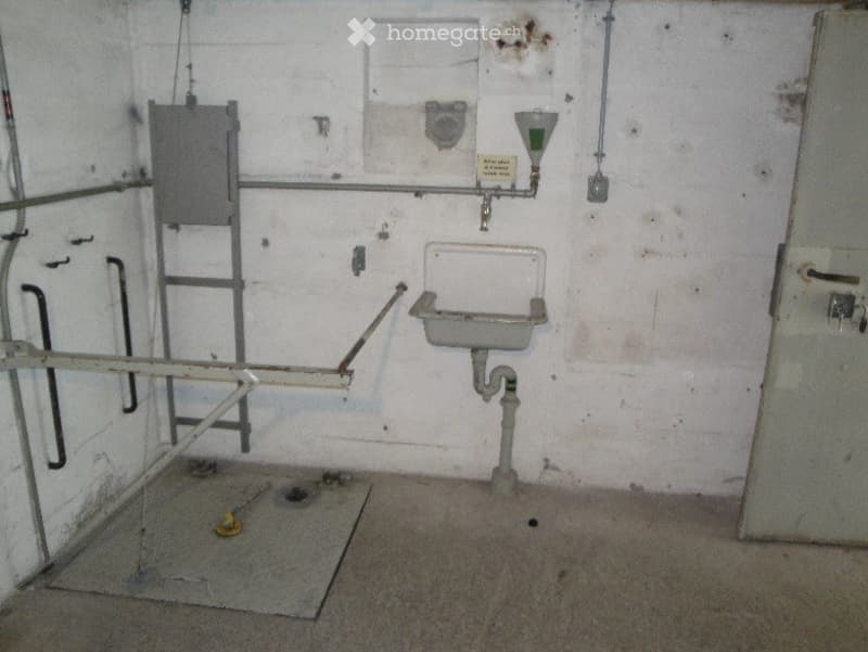 Unfurnished Room. Empty room with a sink, pipes, and a ladder, showing signs of wear and disrepair.