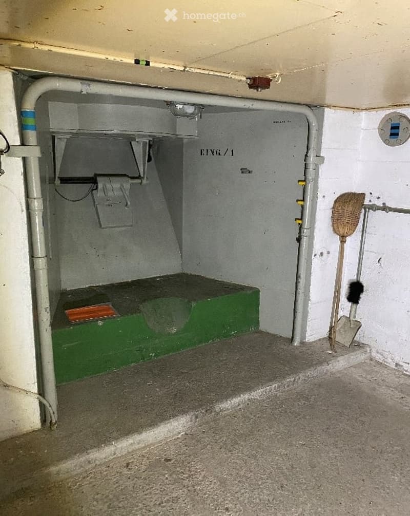 Other. Utility space with a green platform, pipes, and cleaning tools including a broom and dustpan.