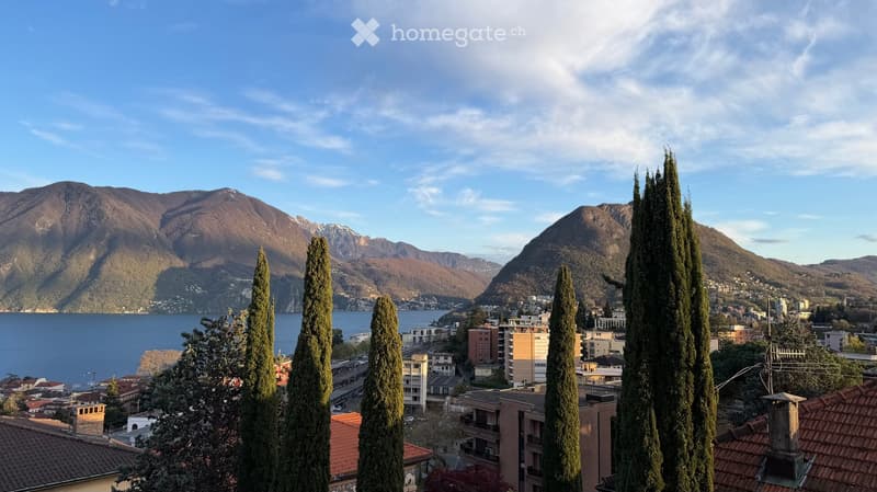 Mountains, lake, town, trees, buildings, clear sky