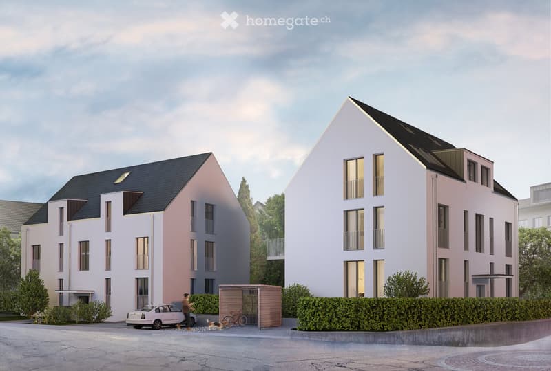 Building. Two modern residential buildings with white and pink facades, large windows, and balconies. The left building has a flat roof with solar panels, while the right building features a triangular roof design. Both buildings have multiple floors and
