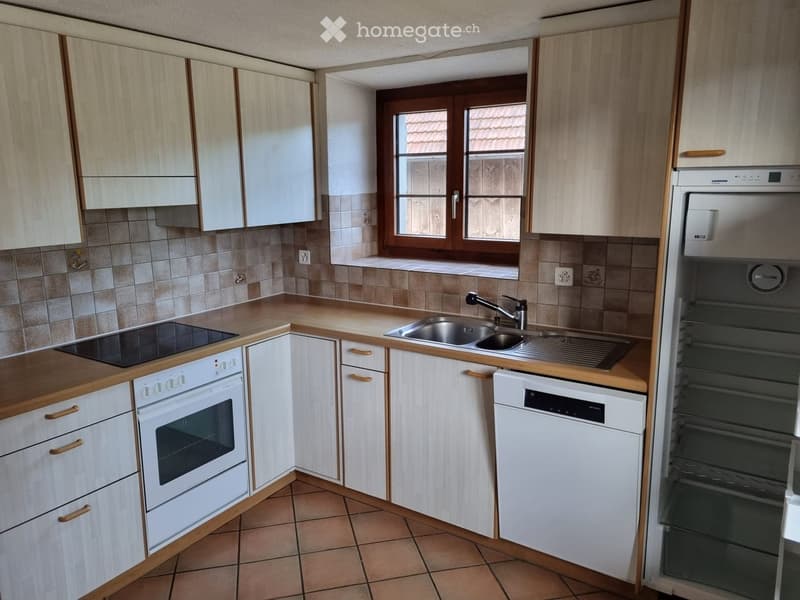 Kitchen. Modern kitchen with light wood cabinets, stainless steel appliances, and a tiled floor.