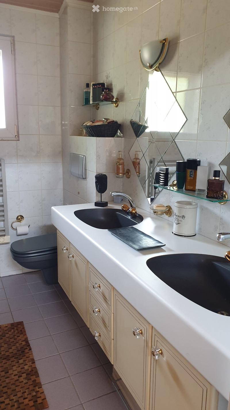 Bathroom. Elegant bathroom with double sink vanity, mirrored cabinet, and modern fixtures.