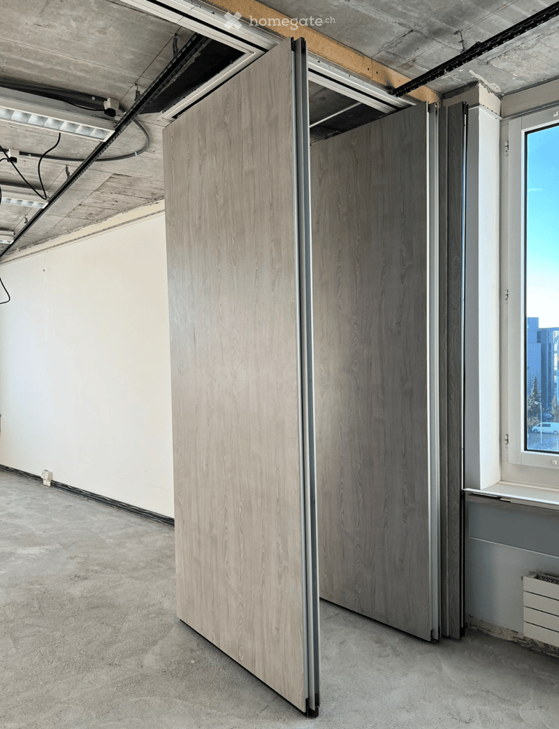 Open folding door, gray walls, gray floor, empty