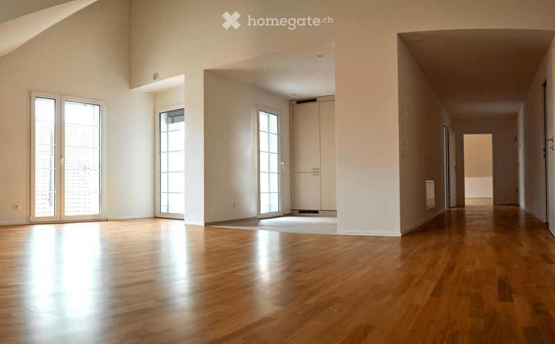 Unfurnished Room. Empty room with polished wooden flooring, large glass doors, and white walls. No furniture or equipment present.