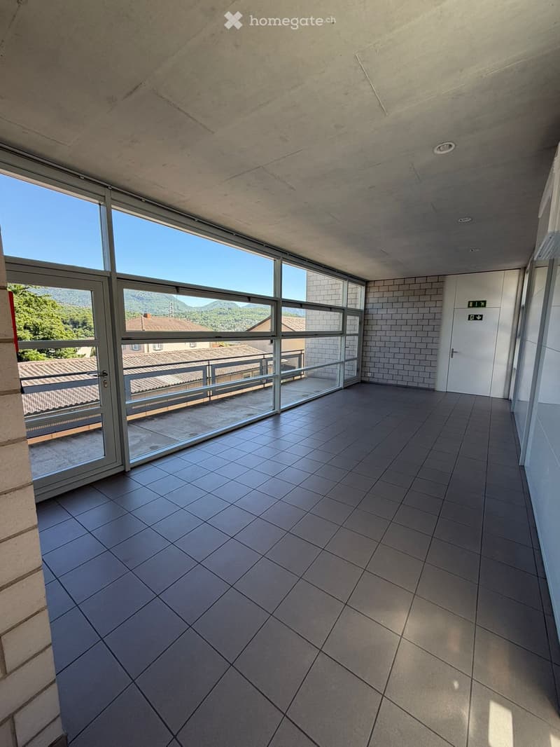 Balcony / Terrace. Empty balcony with large glass doors, tiled floor, and a scenic mountain view.