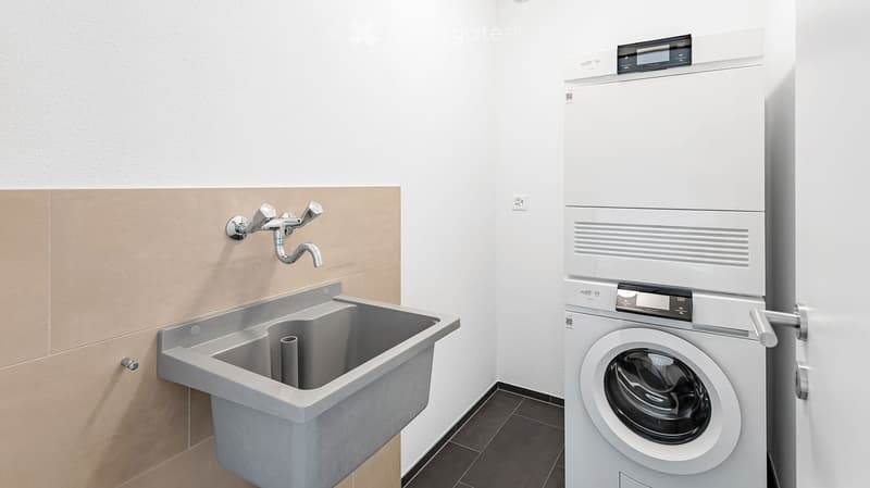 Bathroom. Modern bathroom with a large sink, faucet, and a washing machine.