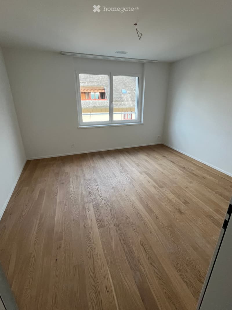 Hardwood floor, large window, open room