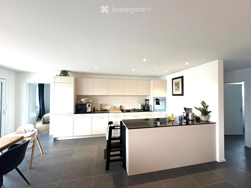 modern kitchen, white cabinets, black counter, white tiles, island, microwave, oven, sink, faucet