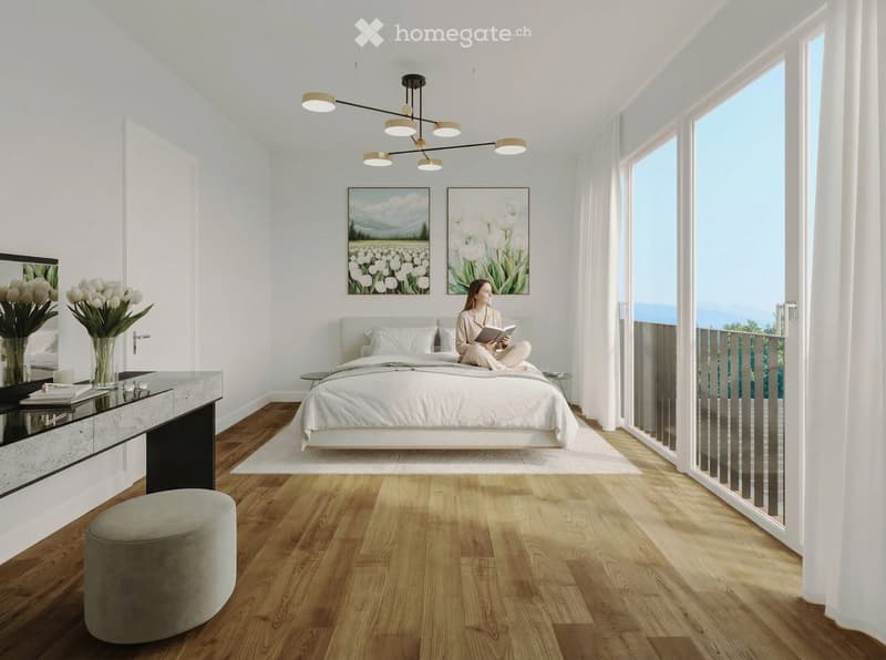 Modern bedroom with a large bed, wooden flooring, a round stool, a vanity with a mirror, and large windows offering a scenic view.