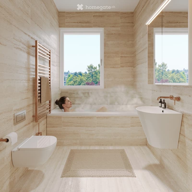 Modern bathroom with beige marble tiles, a freestanding bathtub, a sink with a modern faucet, a toilet, a towel rack with a towel, and a bathroom rug. Large windows offer a view of greenery outside.