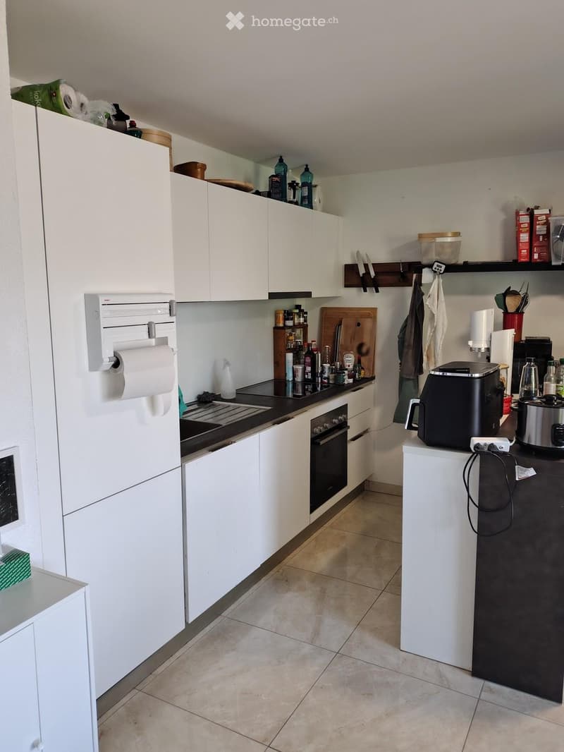 {"type": "Kitchen", "objects": ["refrigerator", "oven", "coffee maker", "toaster", "cutting board", "knife block", "paper towel holder", "cupboard", "bottle", "cup", "bottle", "bottle", "bottle", "bottle", "bottle", "bottle", "bottle", "bottle", "bottle",