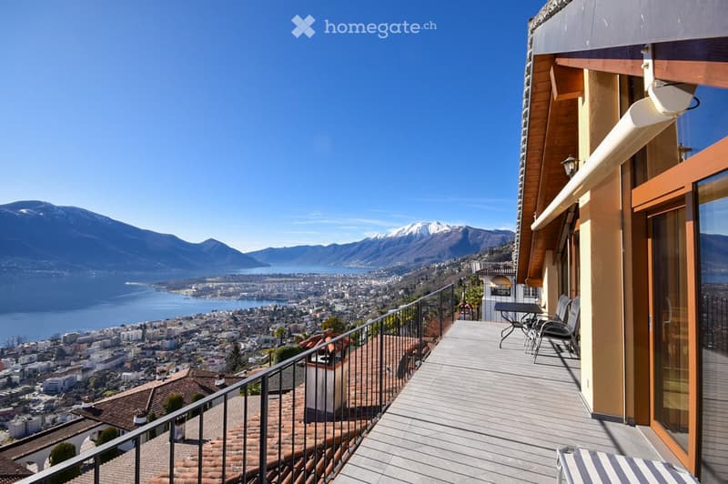 balcony with panoramic view of mountains and city