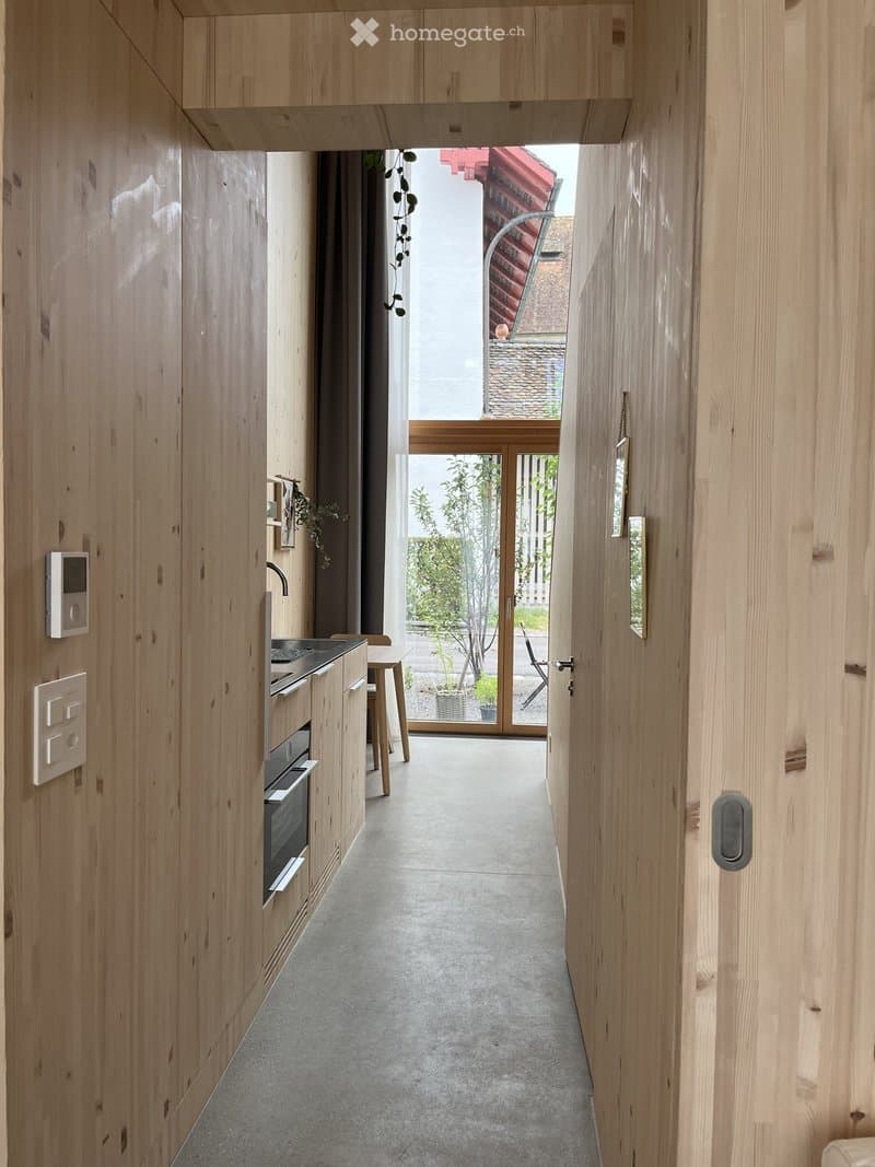 minimalist wooden interior, kitchen area, large windows, pathway, sunlight